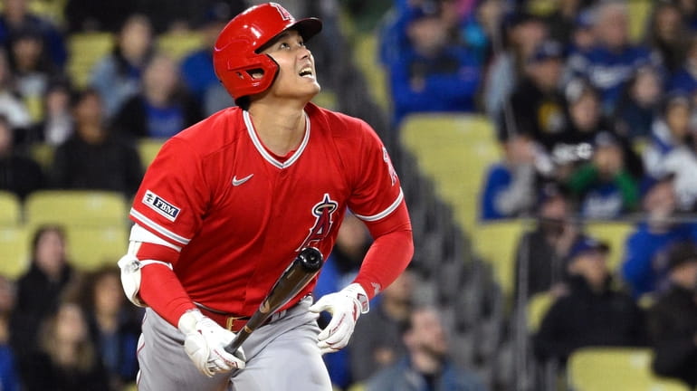 Los Angeles Angels' Shohei Ohtani runs to first as he...