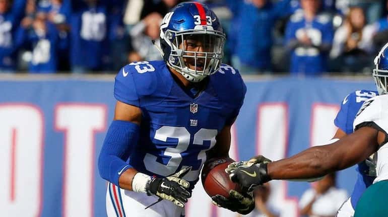 Andrew Adams of the New York Giants runs the ball...