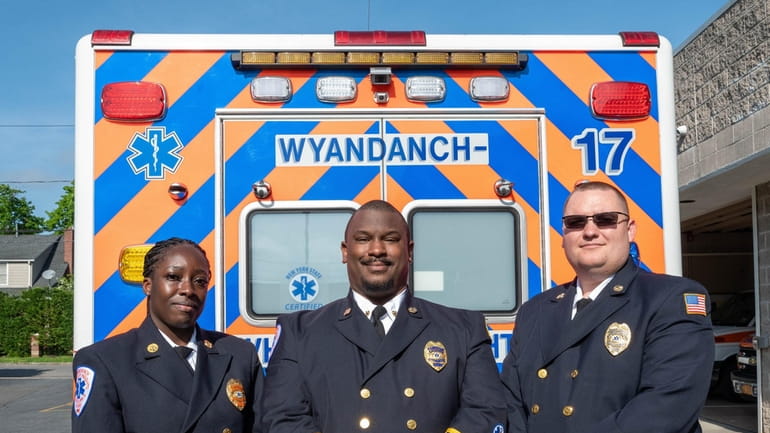 Wyandanch-Wheatley Heights Ambulance Corp. chief Jordan Thomas flanked by second...