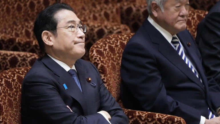 Japanese Prime Minister Fumio Kishida, left, and Finance Minister Shunichi...
