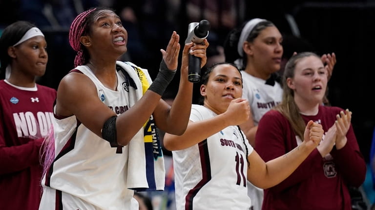 South Carolina's Aliyah Boston cheers from the bench in the...