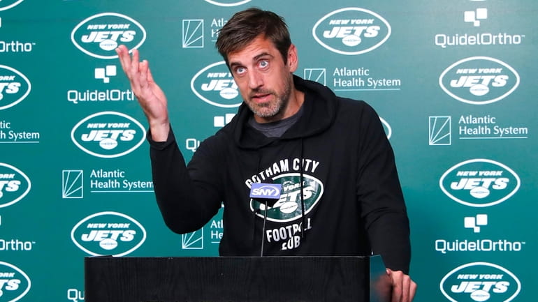 New York Jets quarterback Aaron Rodgers answers questions from reporters...