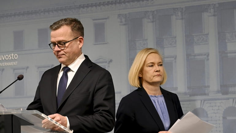 Finnish Prime Minister Petteri Orpo, left, and Interior Minister Mari...