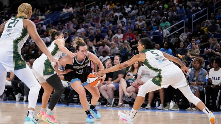 Chicago Sky's Marina Mabrey, third from left, tries to drive...