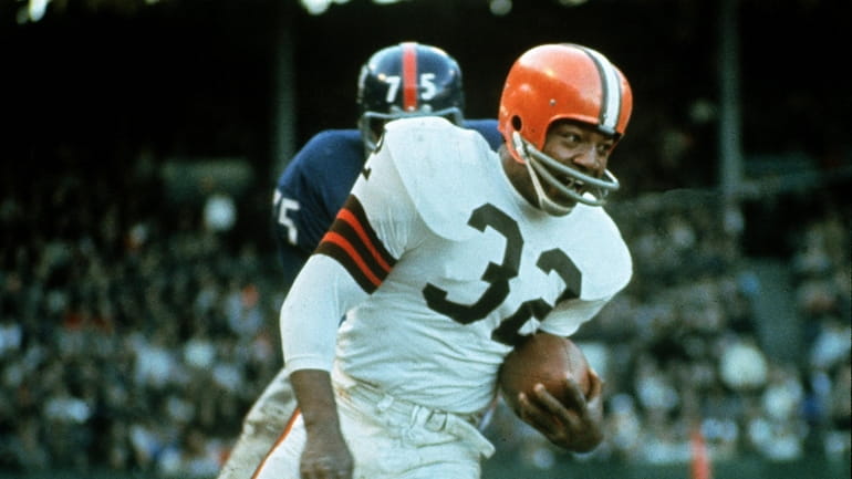 Jim Brown, running back for the Cleveland Browns, against the New York...