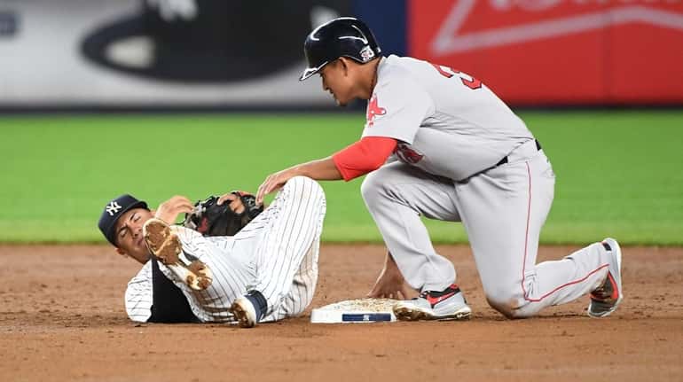 Yankees second baseman Gleyber Torres is pulled of the bag...