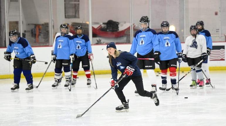 FILE - United States hockey player Haley Skarupa, front, demonstrates...