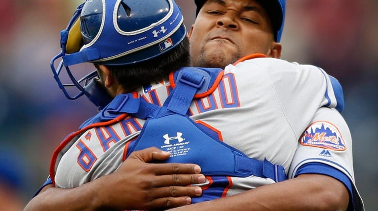 New York Mets relief pitcher Jeurys Familia, right, embraces catcher...