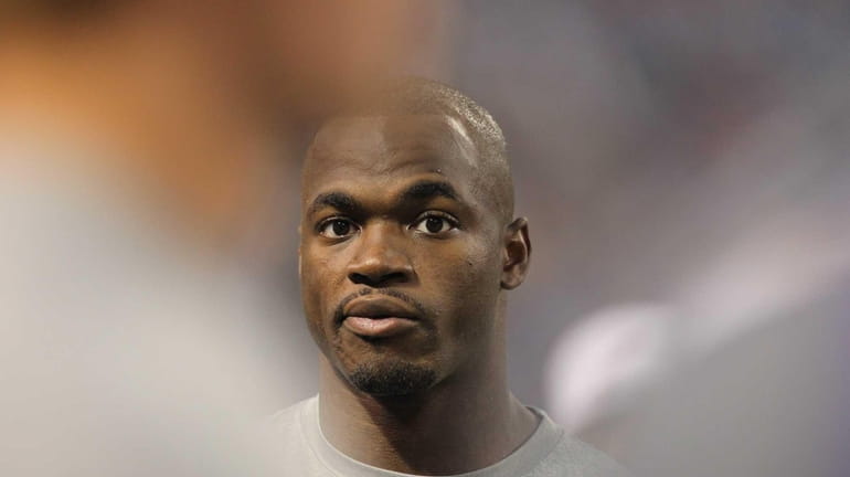 Minnesota Vikings running back Adrian Peterson looks on from the...
