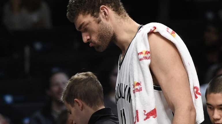 Brooklyn Nets center Brook Lopez goes to the bench after...