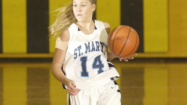St. Mary's Shannon Flynn (14) drives to the basket on...