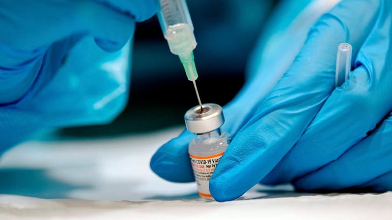 A nurse prepares the Pfizer-BioNTech Covid-19 vaccine for children for distribution...