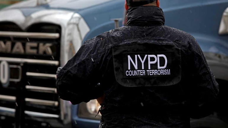 A member of the NYPD counter terrorism division, stands as...