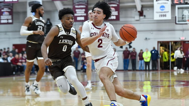 Colgate guard Braeden Smith, right, drives to the basket against...