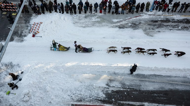 A musher leaves downtown during the ceremonial start of the...