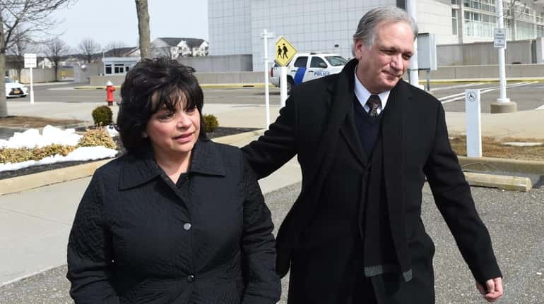 Ed and Linda Mangano leave federal court in Central Islipafter...