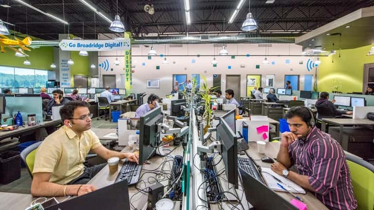 Broadridge Financial Solutions employees work at their investor communications facility...