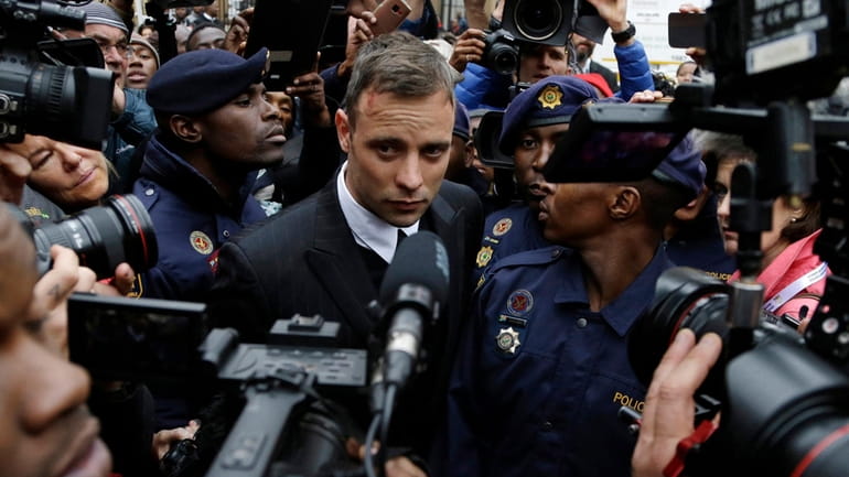 Oscar Pistorius leaves the High Court in Pretoria, South Africa,...