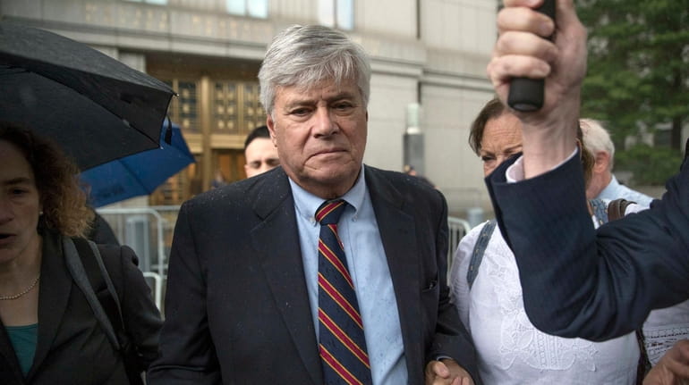 Dean Skelos, center, leaves federal court in Manhattan on Tuesday.
