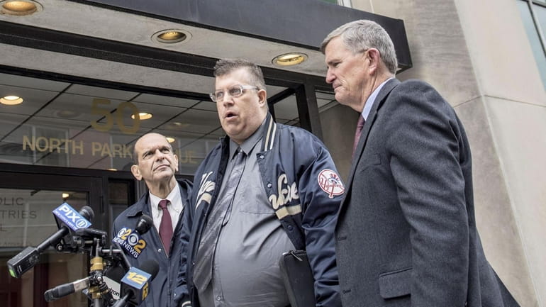 Thomas Mc Garvey, center, is joined by his Attorney, Mitchell...