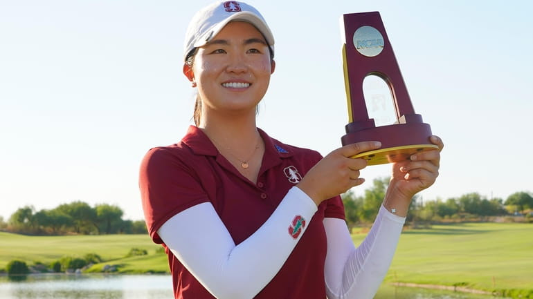 Stanford golfer Rose Zhang holds the champions trophy after the...