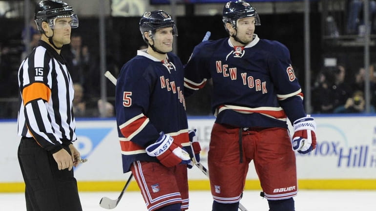 Rangers left wing Rick Nash, right, celebrates his goal with...