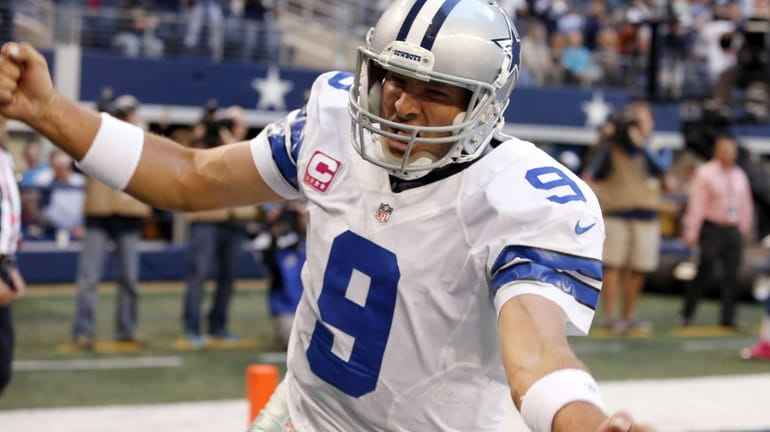 Dallas Cowboys quarterback Tony Romo celebrates his touchdown against the...