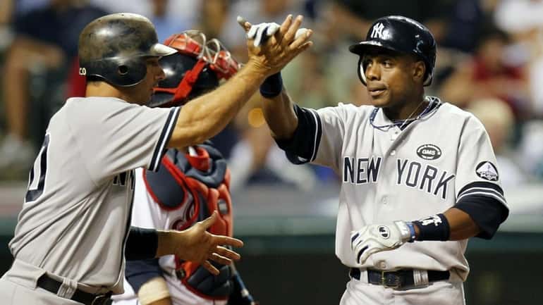 Curtis Granderson celebrates his eighth inning home run with Jorge...