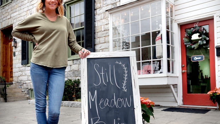 Lacey Larrick poses outside the Still Meadow Boutique, Dec. 17,...