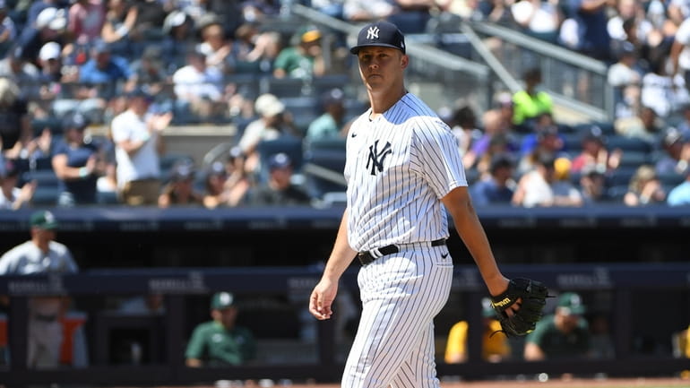 New York Yankees starting pitcher Jameson Taillon walks to the...