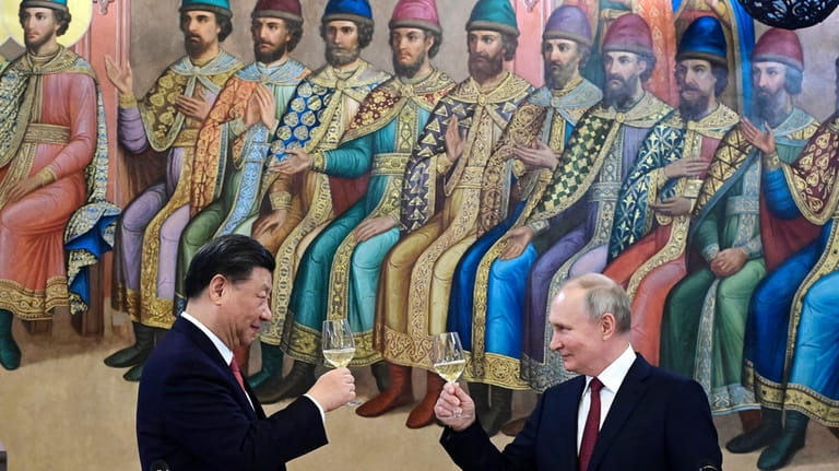 Russian President Vladimir Putin, right, and Chinese President Xi Jinping...