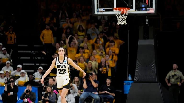 Iowa guard Caitlin Clark (22) reacts after making a three-point...