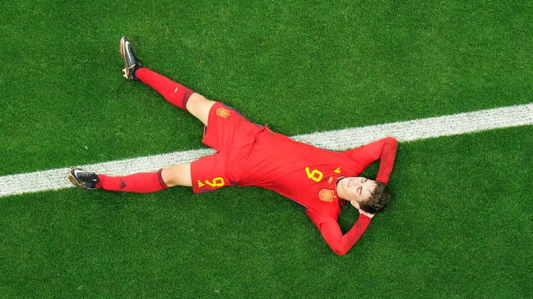 Spain's Gavi lays on the pitch during the World Cup...