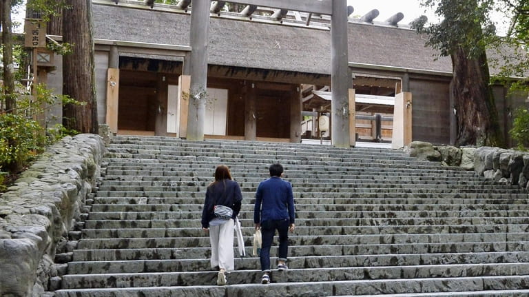 A couple climbs the steps of Ise Grand Shrine, or...