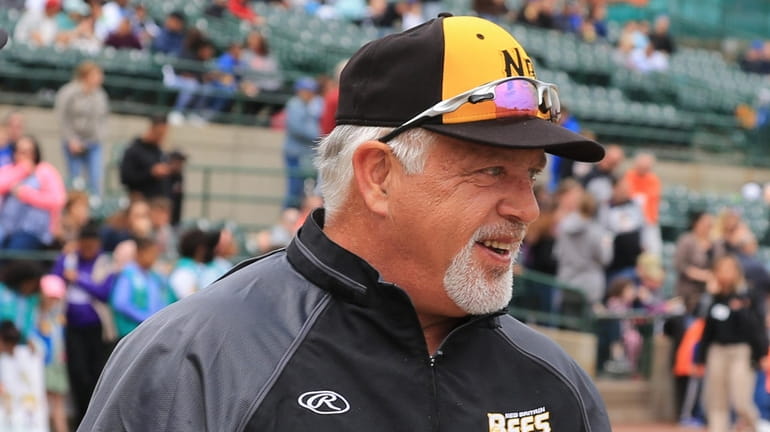 New Britain Bees manager Wally Backman hands in his lineup...