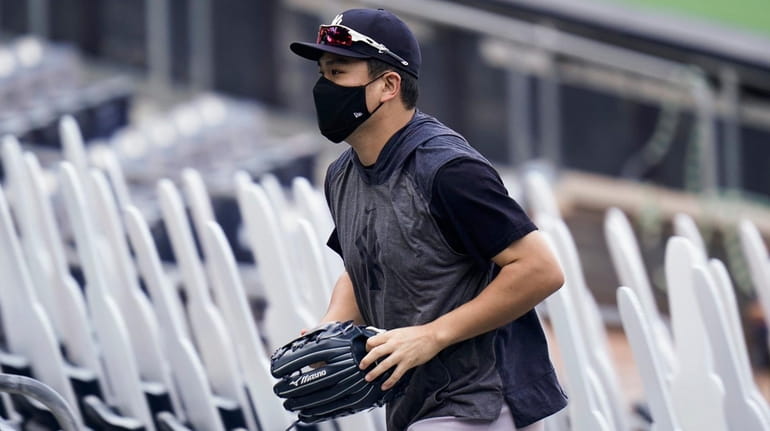 Yankees pitcher Masahiro Tanaka leaves the field after batting practice...