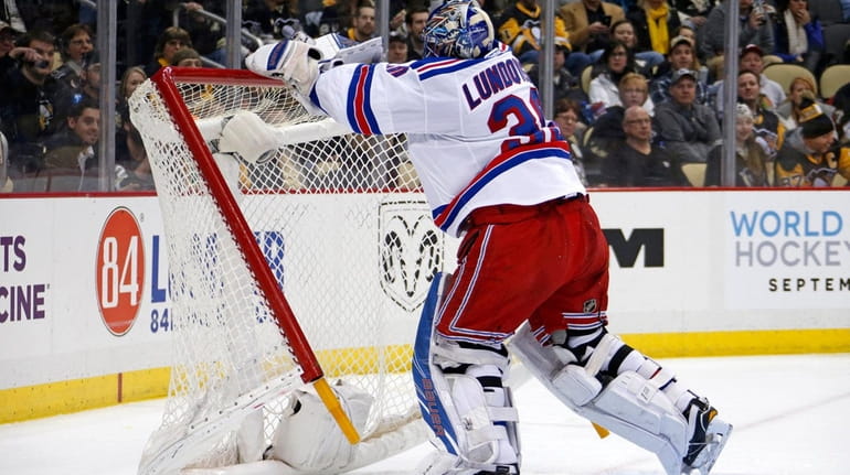 New York Rangers goalie Henrik Lundqvist pushes over the goal...