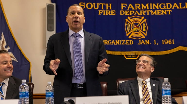 Former New York Gov. David Paterson, standing, who now works for...