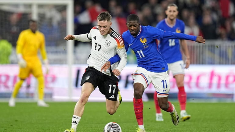 Germany's Florian Wirtz, left, challenges for the ball with France's...