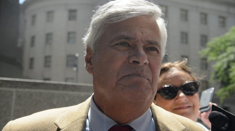 Dean Skelos, left, and his wife, Gail, right, exit a...