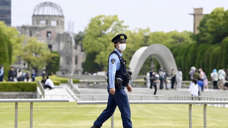 A police officer works at the Peace Memorial Park, where...