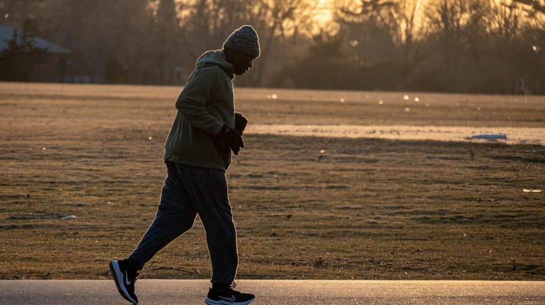 A runner navigates Eisenhower Park in East Meadow at sunset...