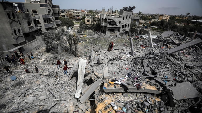 Palestinians inspect the damage to a residential building for the...