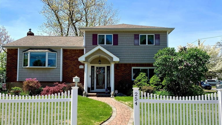 This $669,000 North Babylon home has a bi-level deck overlooking...