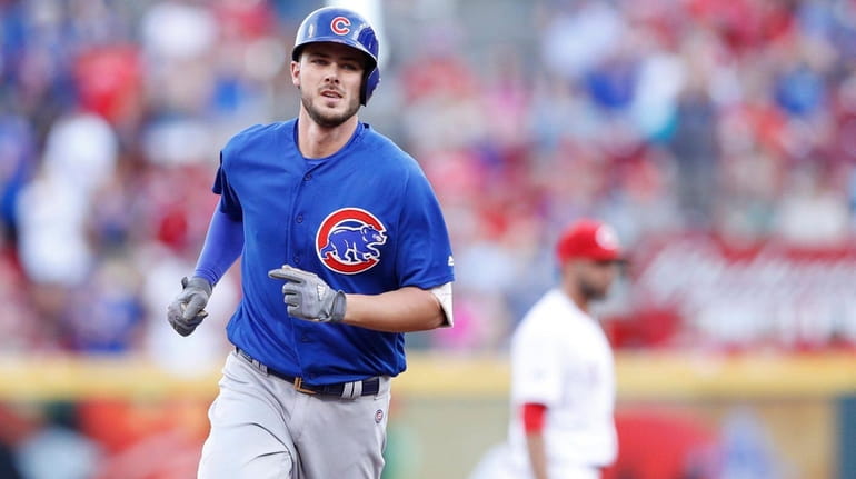 Kris Bryant of the Chicago Cubs rounds the bases after...