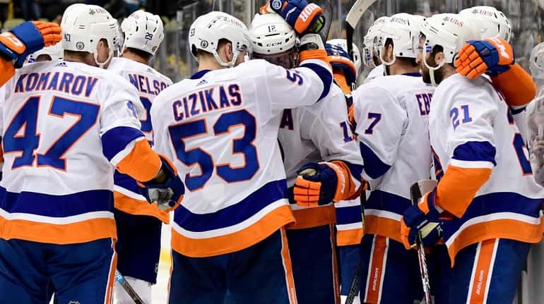 Casey Cizikas #53 of the New York Islanders hugs Josh...
