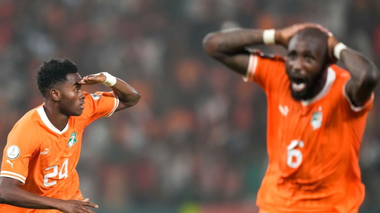 Ivory Coast 's Simon Adingra, left, celebrates after scoring his...