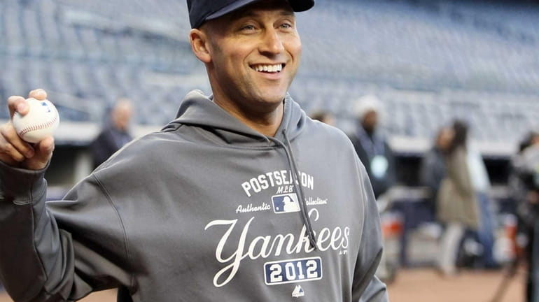 Derek Jeter of the New York Yankees warms up before...