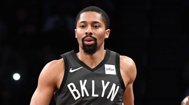Nets guard Spencer Dinwiddie dribbles the ball up court against...