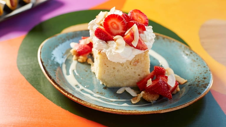 Coconut tres leches cake with coconut custard, strawberries and coconut...